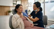 © Jai Izzam - Dentist examining teeth of pregnant patient in dental clinic