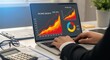 © The Little Hut - Business professional analyzing financial growth charts and data on a laptop screen in an office setting