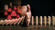 © Murfolio - Hand Stopping Domino Effect to Prevent Further Business Risk