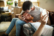 © Davor - Loving couple cuddling on sofa in new home
