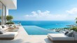 © Jannata - Luxurious elevated patio area features an infinity edge swimming pool overlooking a vast azure ocean and coastal settlement.