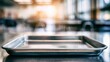 © crazyass - Empty stainless steel lunch tray on a cafeteria table with warm sunlight and blurred dining room background conveying a quiet, clean foodservice atmosphere