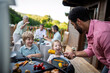 © Halfpoint - Man grilling meat and vegetable on grill during family summer garden party.