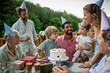 © Halfpoint - Multi generation family celebrating birthday on terrace.