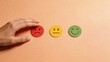 © olga_demina - A conceptual representing emotional assessment and risk management, with a hand choosing a red frowning face from a set of emoticons.