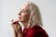 © Amor Burakova/Stocksy - Profile of blonde senior woman