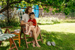 © Pietro Karras/Stocksy - Woman and child sitting together under tree in garden