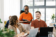 © Mihajlo Ckovric/Stocksy - Group of People Working Together in Modern Office Space