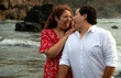 © Luis Herrera/Stocksy - candid Young Couple Laughing Together on Beach at Sunset