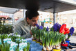 © Diego Martin/Stocksy - Man Enjoying the Scent of Spring Hyacinths at an Outdoor Stall