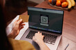 © Elena Kharichkina/Stocksy - Person uses card next to laptop for online shopping