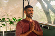 © Satya Gautam/Stocksy - Man With Hands Together Smiling in Indoor Setting During Daytime