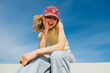 © BONNINSTUDIO/Stocksy - Blonde woman laughing enjoying sunny day outdoors