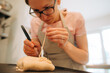 © Olga Moreira/Stocksy - Detailed pastry work with dough and tool
