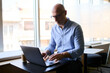 © Dimitrije Tanaskovic/Stocksy - Businessman typing on a laptop