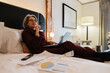 © Angel Santana/Stocksy - Business planning and thinking while working in bed