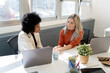 © Santi Nuñez/Stocksy - Diverse women collaborating on business project in office