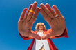 © Basil Pind/Stocksy - Low angle portrait of woman framing view with hands