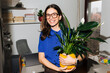 © Brat Co/Stocksy - Happy Woman Holds Peace Lily