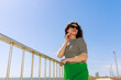 © valbar STUDIO/Stocksy - Woman Poses by the Sea on a Sunny Day