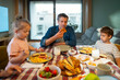 © Artcore Studio/Stocksy - Family enjoys breakfast together in a home setting