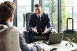 © Guille Faingold/Stocksy - Business Talks in Hotel Lounge