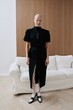 © Serge Filimonov/Stocksy - Fashion portrait woman in black dress in interior