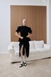 © Serge Filimonov/Stocksy - Luxury fashion portrait woman pose before white sofa