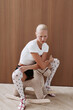 © Serge Filimonov/Stocksy - Studio portrait woman sit on rocking horse