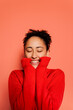 © BONNINSTUDIO/Stocksy - Woman feeling happiness and excitement on orange background
