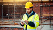 © peopleimages.com - Man, construction or civil engineering with tablet in scaffolding for building inspection on site. Male person, architect or security check with technology for architecture development or maintenance