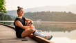 © Zedspider - Woman running by the lake on a sunny day. Active lifestyle and outdoor fitness concept.
