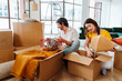 © oneinchpunch - Happy young couple relocating in a new apartment.