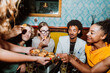 © oneinchpunch - Friends party enjoying social gathering and snacks