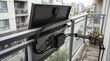 © Pavlinka - Balcony Solar Panel Installation Detail with Wiring on Urban Railing.