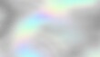 © kastanka - Colorful iridescent, holographic rainbow foil texture, gradient background for prints. Noise textured surface.