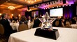© Pixim Stock - Crystal star award trophy sits on table, elegant formal event gala background, guests dining, chandeliers hanging overhead, sophisticated celebratory ambiance indoors.