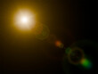 © SRTember - Bright golden sun lens flare with polygonal bokeh ghosts isolated on black background.