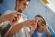 © Miljan Živković - Young people glued to smart phones connected to digital world