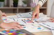 © Natee Meepian - Women designers collaborating on UI UX mobile app wireframe planning