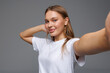 © F8  \ Suport Ukraine - Beautiful woman make selfie by camera over isolated white background