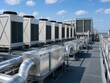 © Cantarela - Industrial air conditioning units on data center roof. Infrastructure for server cooling system. Climate control technology equipment for facility ventilation and thermal management.