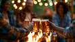 © Laura - Faceless group of mature friends sitting around fire and making a toast at outdoor campsite bar, fireside celebration, toast moment, beverage sharing, with copy space