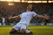 © Denkun - Passionate soccer player in white jersey kneeling and celebrating victory in a stadium at sunset. Professional athlete cheering after scoring a goal during football match at golden hour.