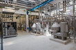© Dragan - Modern industrial factory interior with stainless steel pipes and processing machinery. Clean automated production line in food, dairy, or chemical plant engineering industry.