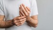 © Bonsales - Person feeling discomfort, rubbing fingers and wrist, representing pain, injury, or carpal tunnel syndrome concept