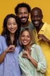 © Iryna - Happy diverse friends posing with heart hands against a yellow background for vibrant social media banner and advertising use
