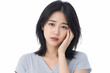 © maaagram - 頬に手を当てて悩む若い女性 Generative AI