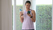 © ChayTee - Young gen z active woman drink whey creatine shake bottle eating diet food using phone calorie plan app after home sport workout. health care asia people happy relax protect aging life weight loss.