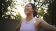 © ChayTee - Asia young Gen Z people mindful happy woman open arm relax body deep stress relief outdoor nature green public park sun light self love anti aging life asian female mental health care modern medical.